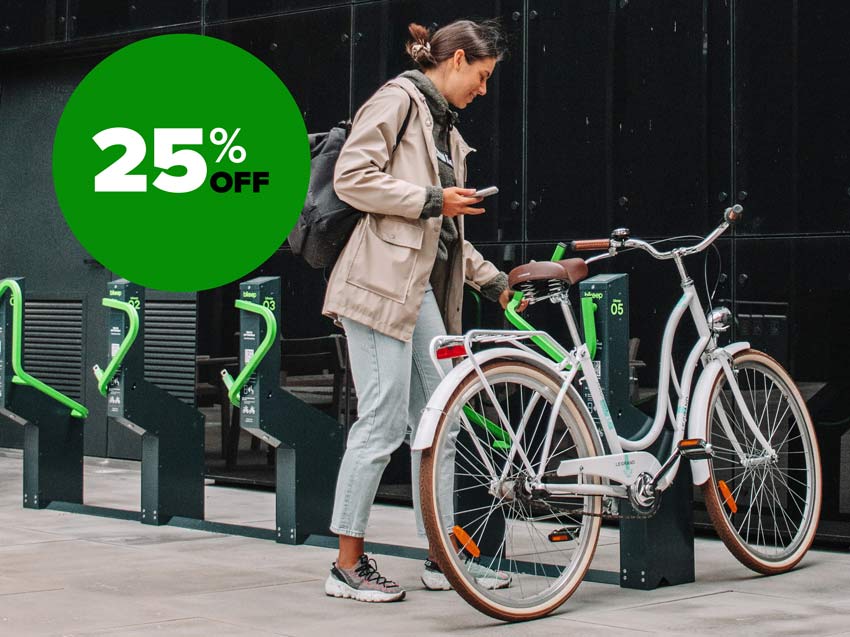 Woman parking bike in smart bike docks